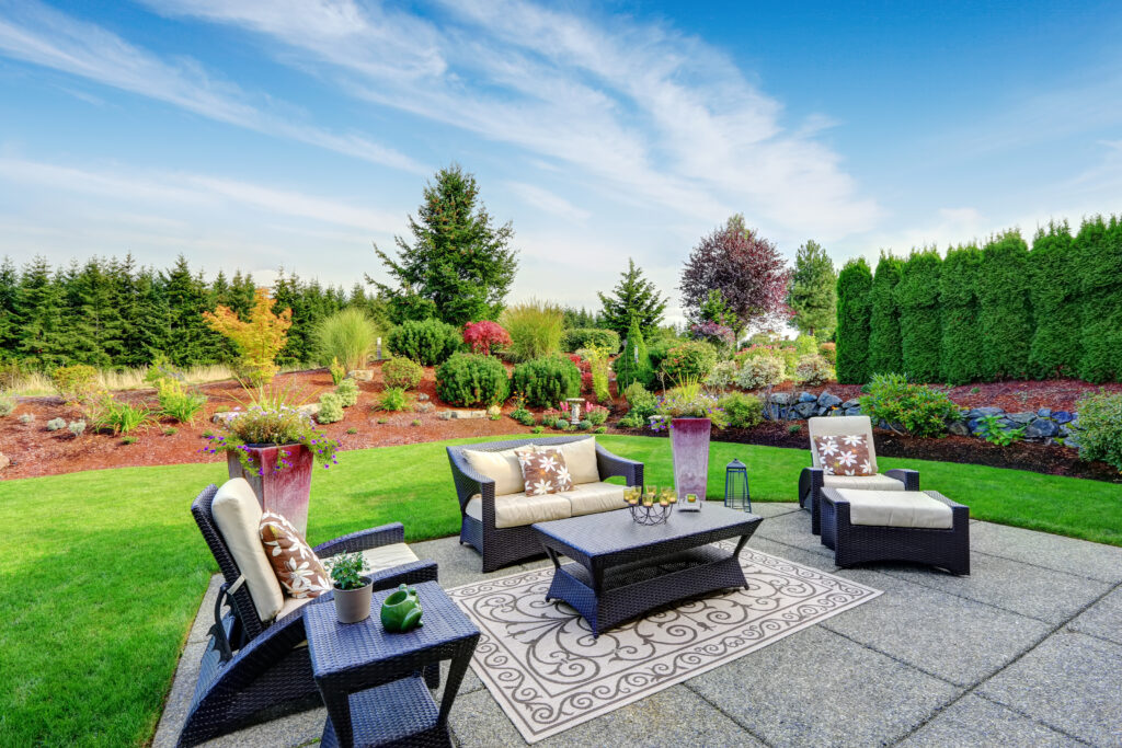 Get Your Patio Ready For Summer With These 7 Suggestions Impressive backyard landscape design. Cozy patio area with settees and table. Patio Ready for Summer